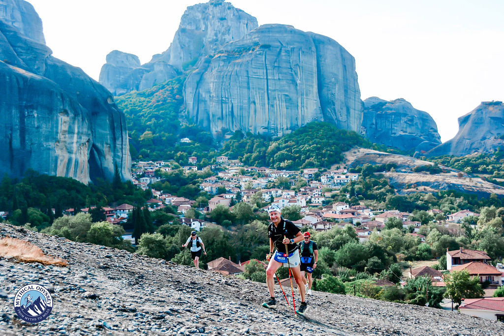 Roberto Rivola climbing with poles below the Meteora rock towers during the Mythical Odyssey mountain stage race in Greece